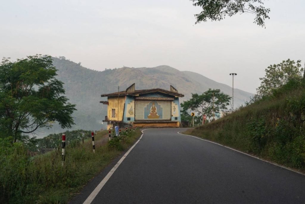 A building at a turning point of a road.