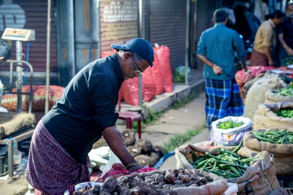 Vegetable vendor arranging vegetables