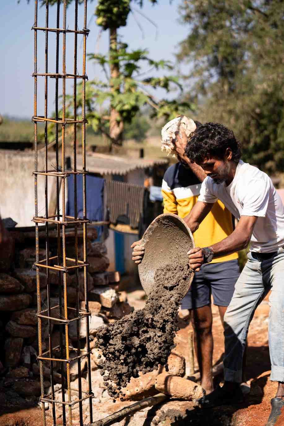 a man is pouring the concrete