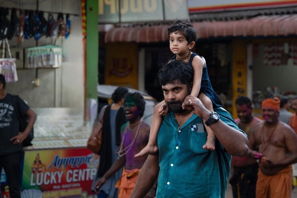 father take care of child carrying on shoulders