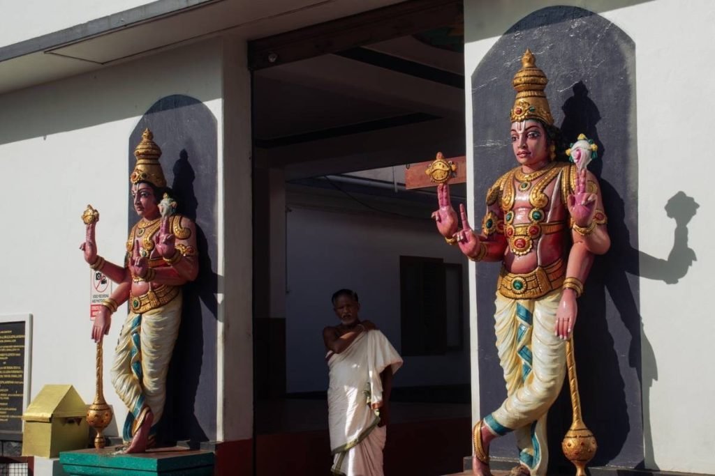 holy presence of vaishnava temple with a priest standing in the middle.