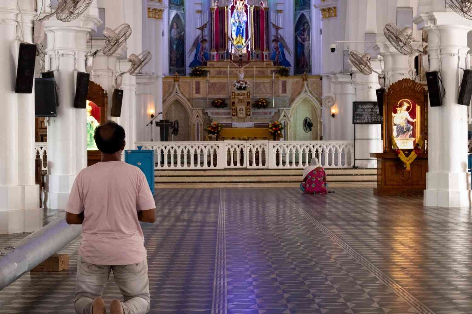 Some kneeling devotees in church