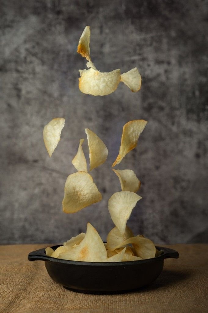 Tapioca chips dropping in a bowl.