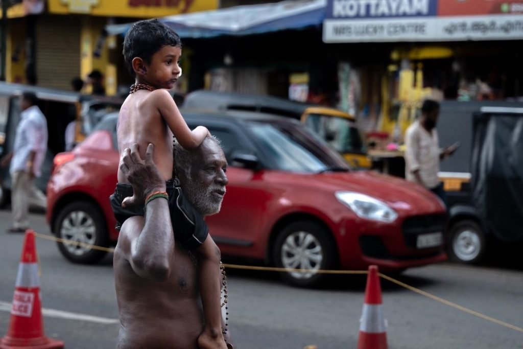 grandfather carrying his grandson on his shoulders