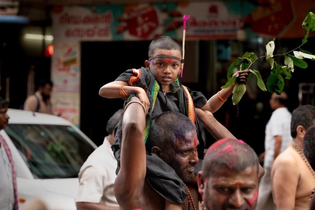 father carrying Malappuram on his the shoulder