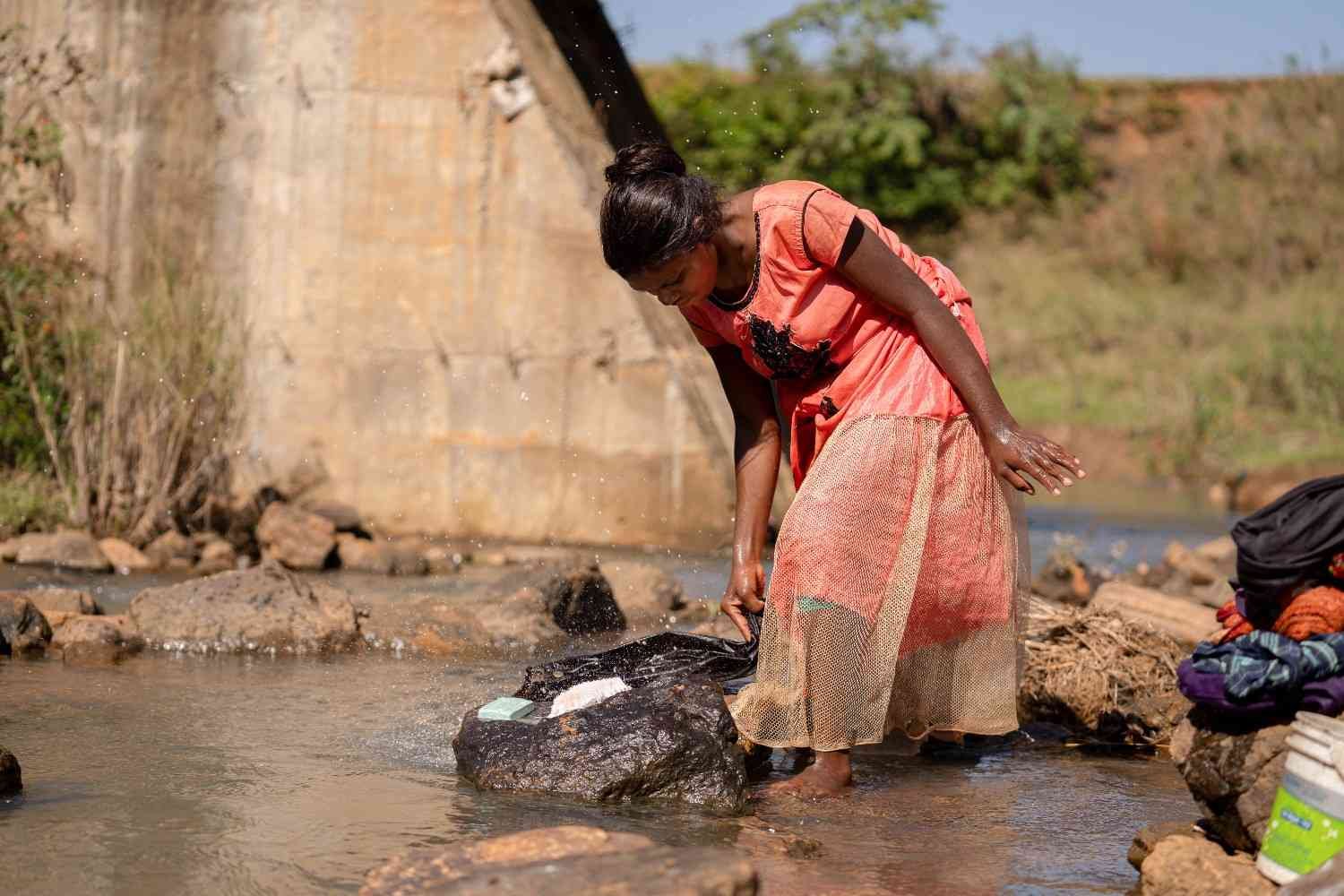 a girl is washing cloths