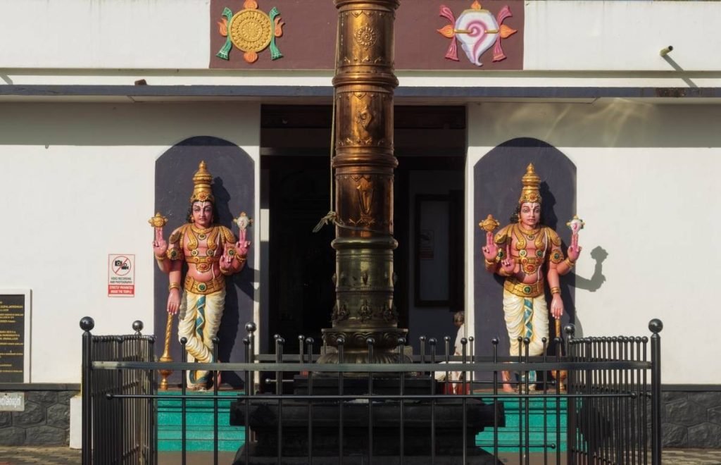 sculpted guardians of vaishnava temple with 2 sculptures in front.