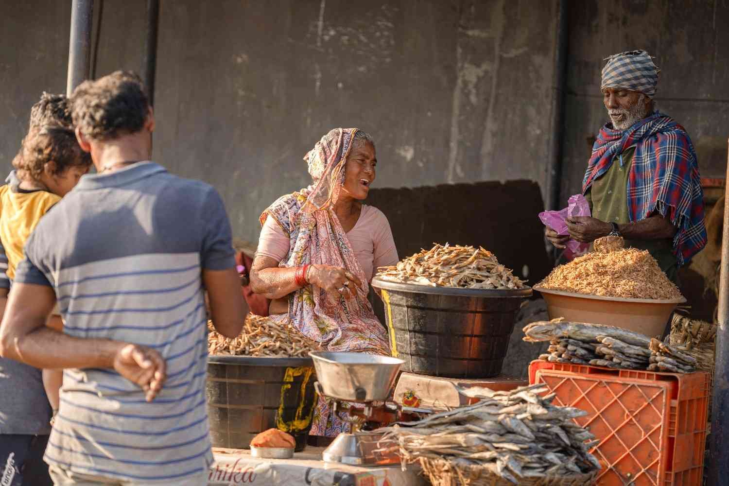 a old lady is selling dry fish