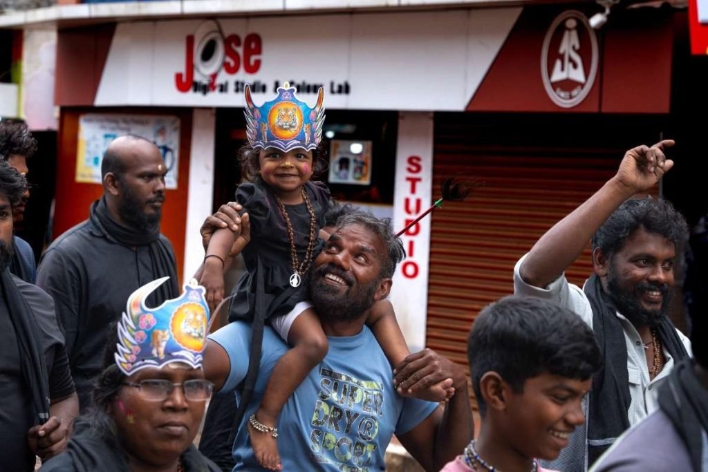 father carrying Malappuram on his the shoulder