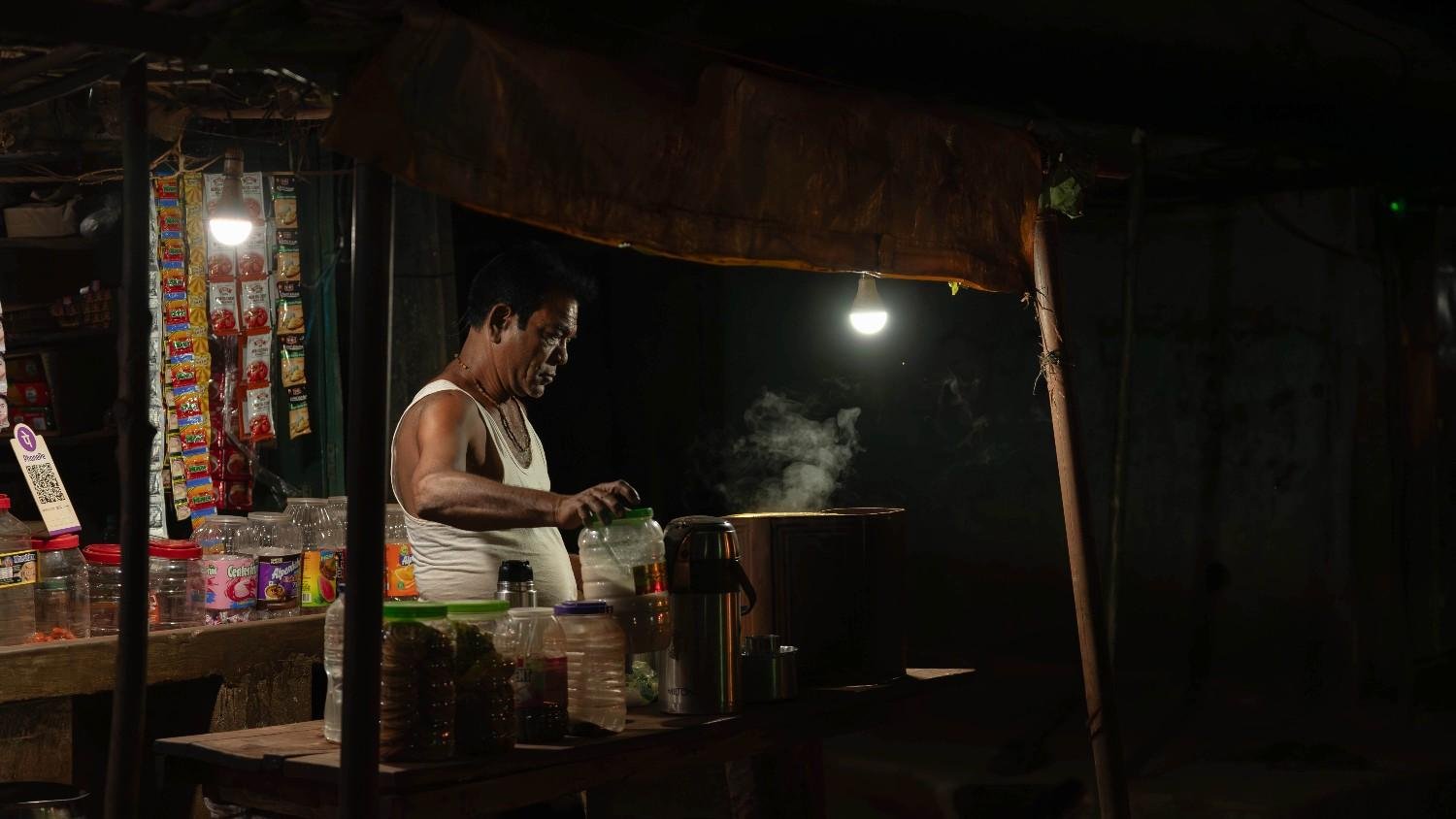 a men is putting coffe in the night
