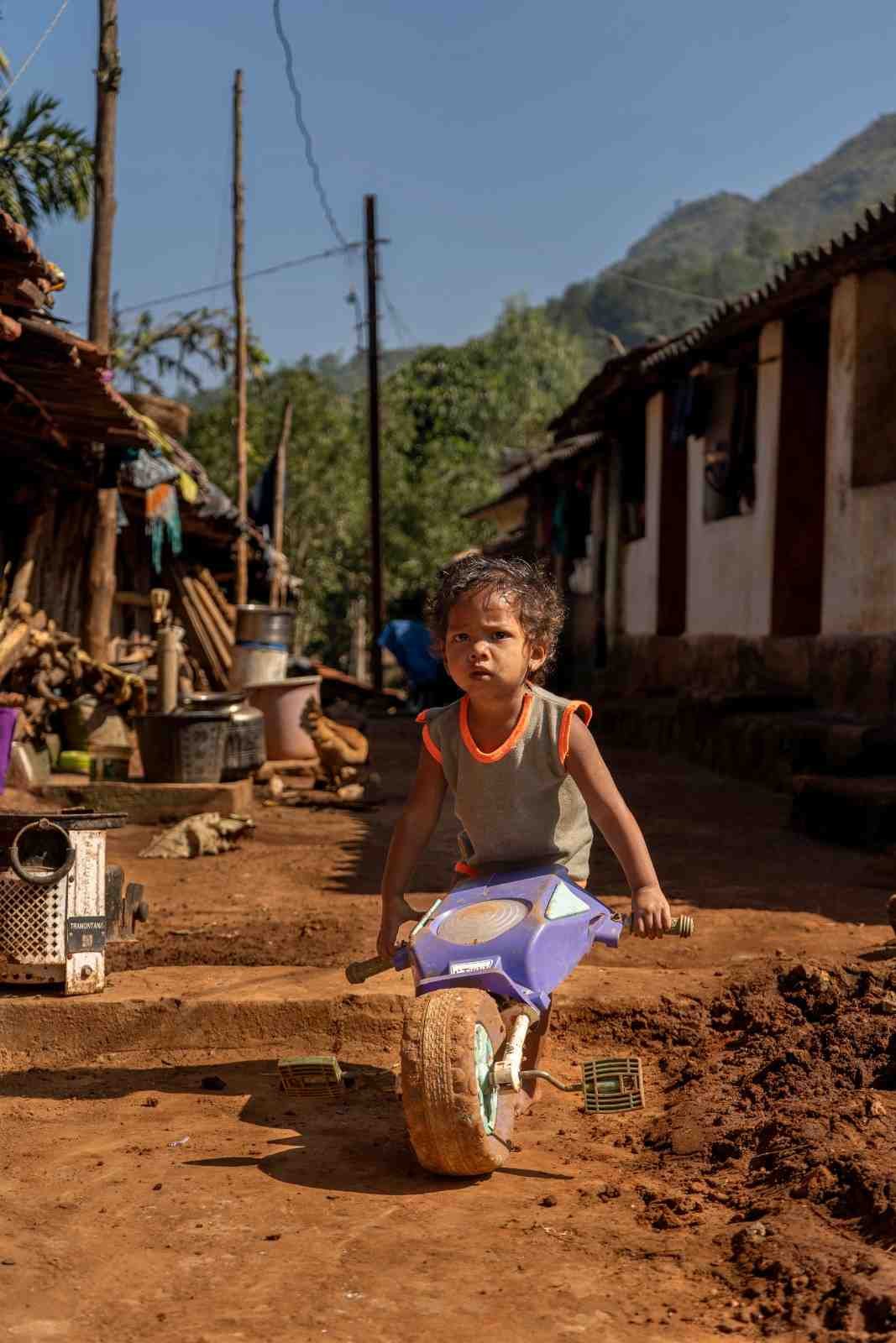 a small boyis playing at the street