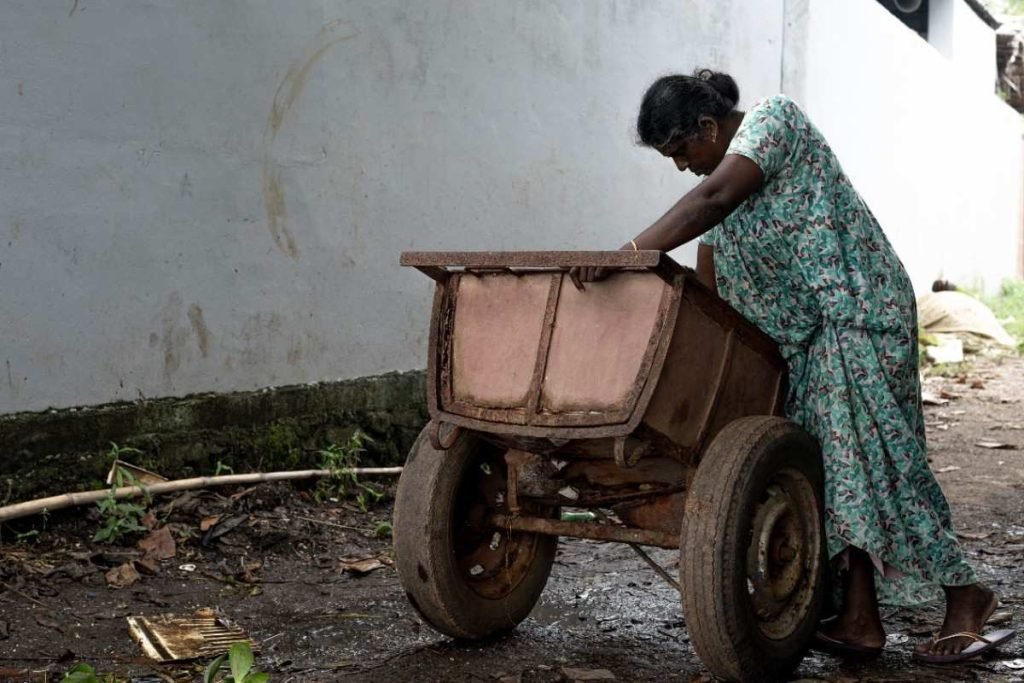 Clams Cleaned A woman pushes a rusty cart.