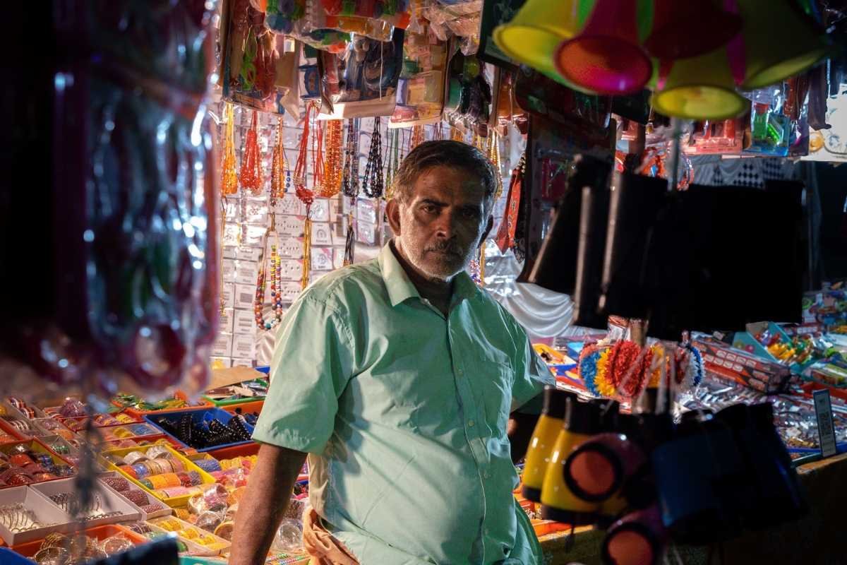intent stare of a man standing in front of stall.