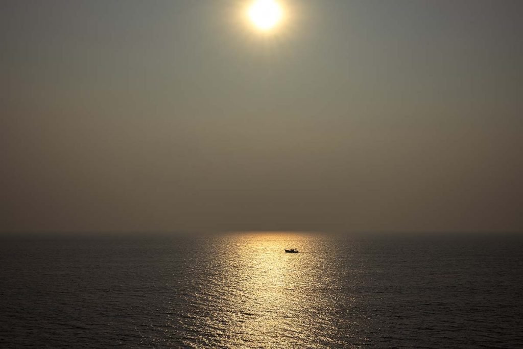 In the wild sea a single boat going alone