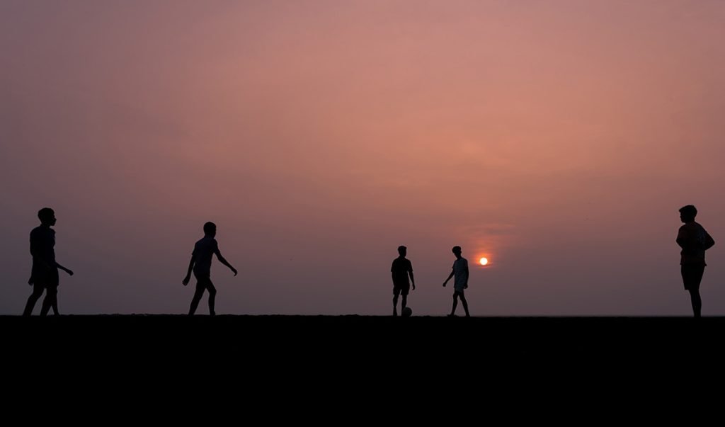 The kickoff of a football match on the beach
