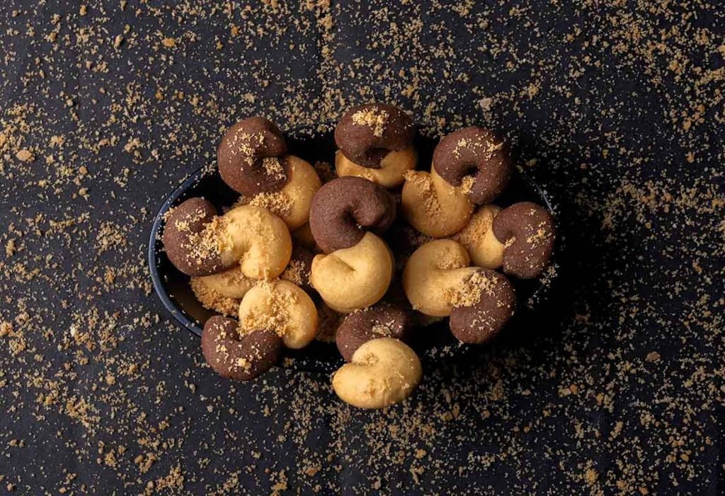 Twisted chocolate treats with scattered crumbs.